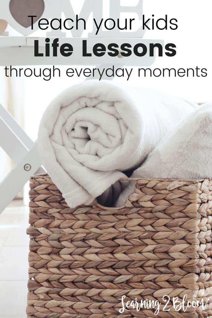 White rolled up towel on basket with title "Teach kids life lessons through everyday moments."