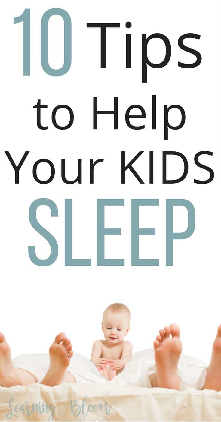 Bed with 2 sets of adult feet showing and baby sitting up between them. Title "10 Tips to Help Your KIDS Sleep"