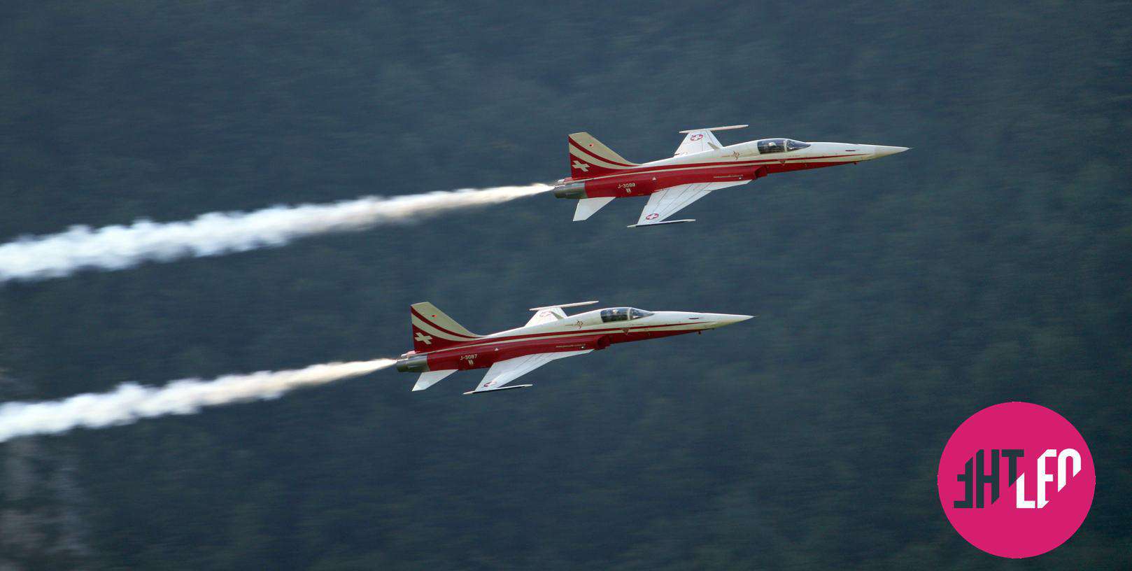 2 red and white jets flying