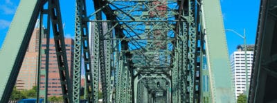 Driving on bridge with large greenish beams