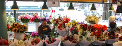 flower bouquets at pikes place surrounding man selling