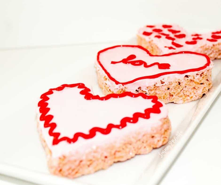 Valentines Day Rice Krispie Treats. If you love pink and you love sweets this is the perfect heart shaped treat for your Valentine's day.