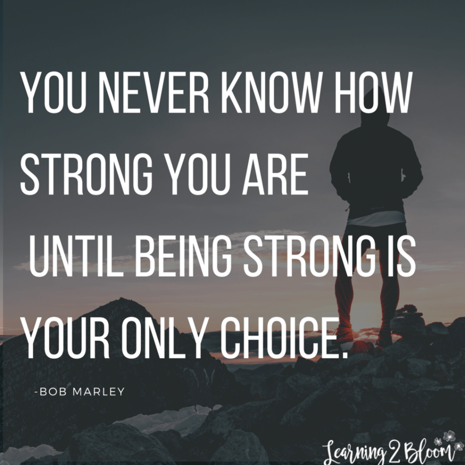 Person standing on rocks with quote by Bob Marley "You never know how strong you are until being strong is your only choice"