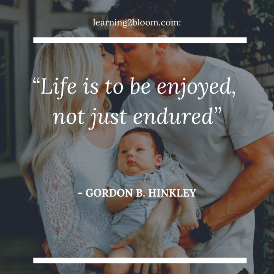 Man and woman kissing and holding baby with quote “Life is to be enjoyed, not just endured”