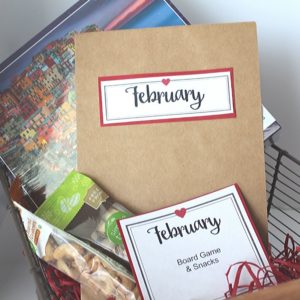 Basket filled with February date night ideas. Puzzle, snacks (nuts)
