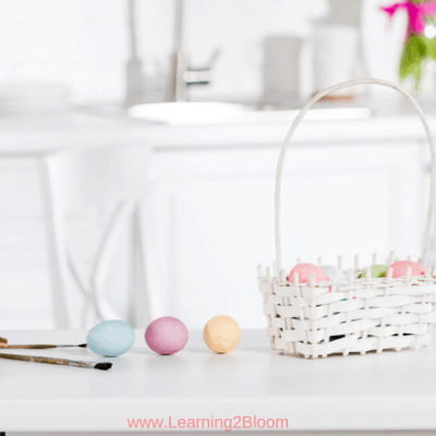 white Easter basket with colored eggs on kitchen counter