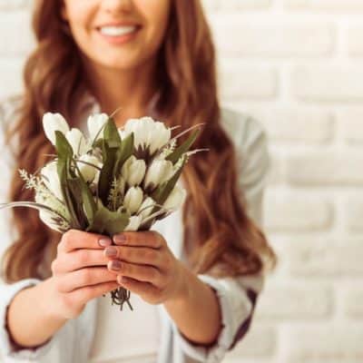 Woman giving white flowers